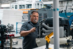 Worker working on a Gulf Suzuki outboard.