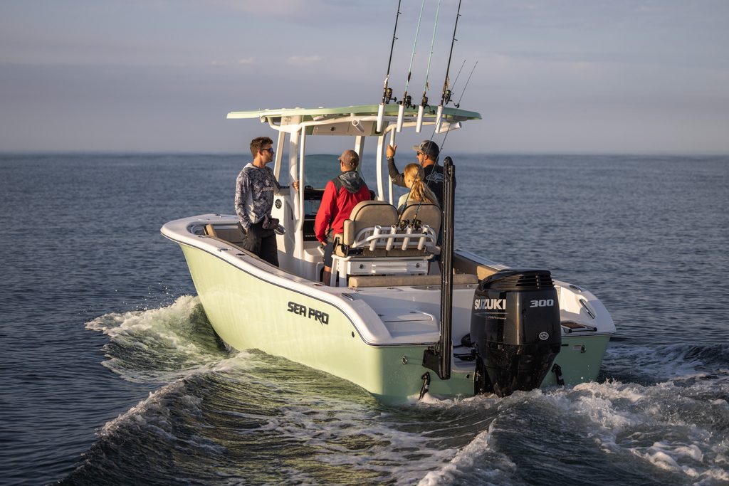 Small boat with a Gulf Coast Suzuki outboard on a body of water with four people on the boat.